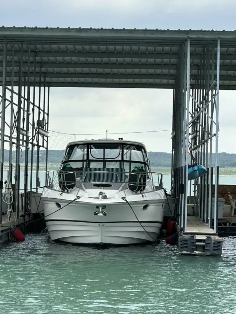 Slide: The Image of A 2007 Regal Commodore 4460 docked in a covered slip on the water. - 1