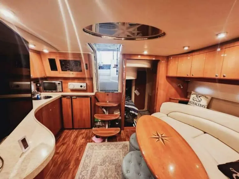 Slide: The Image of The interior cabin of the 2007 Regal Commodore 4460 features an elegant kitchen and cozy seating area. - 17