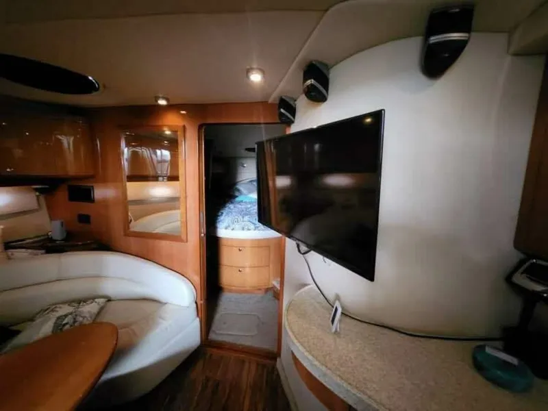 Slide: The Image of Interior of a 2007 Regal Commodore 4460 with cozy seating area and flat-screen TV. - 8