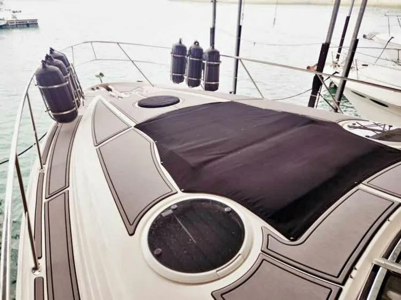 Slide: The Image of The 2007 Regal Commodore 4460 features a spacious foredeck with sun pad and porthole. - 5