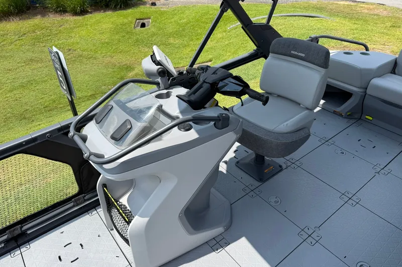 Slide: The Image of 2023 Sea-Doo Switch Sport 21 helm with modern controls and seating on a sunny day. - 8