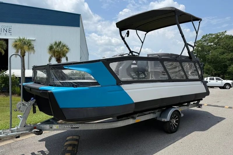 The Image of 2023 Sea-Doo Switch Sport 21 pontoon boat on trailer, parked outdoors. - 0