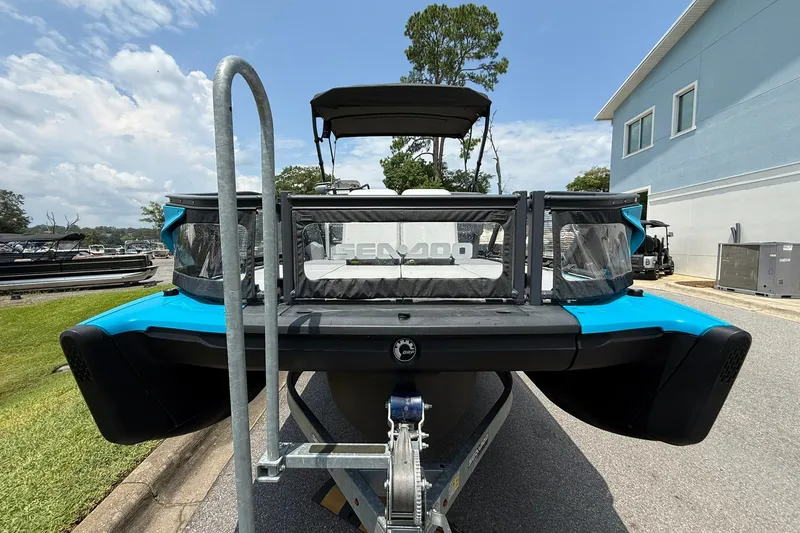 Slide: The Image of 2023 Sea-Doo Switch Sport 21 on trailer, vibrant blue, parked outdoors. - 5