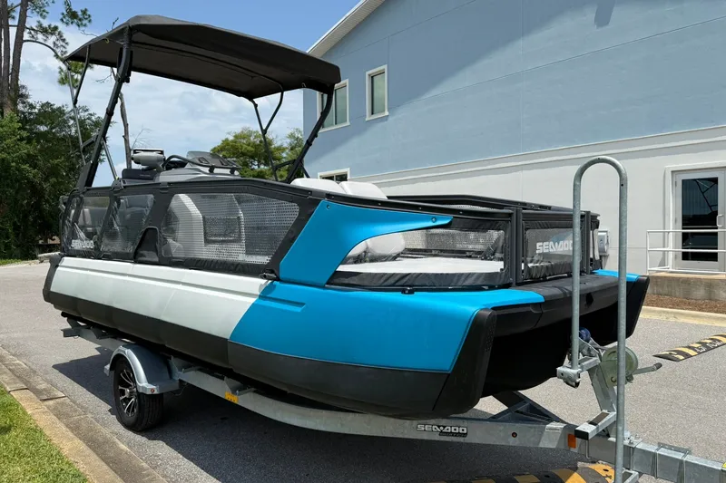 Slide: The Image of 2023 Sea-Doo Switch Sport 21 on trailer, featuring sleek blue and white design. - 4