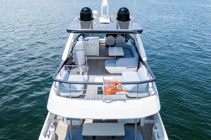 Slide: The Image of 2023 Azimut Fly 68 yacht with spacious deck and luxurious seating on open water. - 94