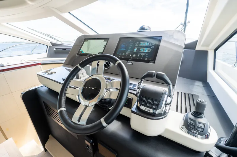 Slide: The Image of 2023 Azimut Fly 68 yacht helm with advanced navigation controls and sleek design. - 61