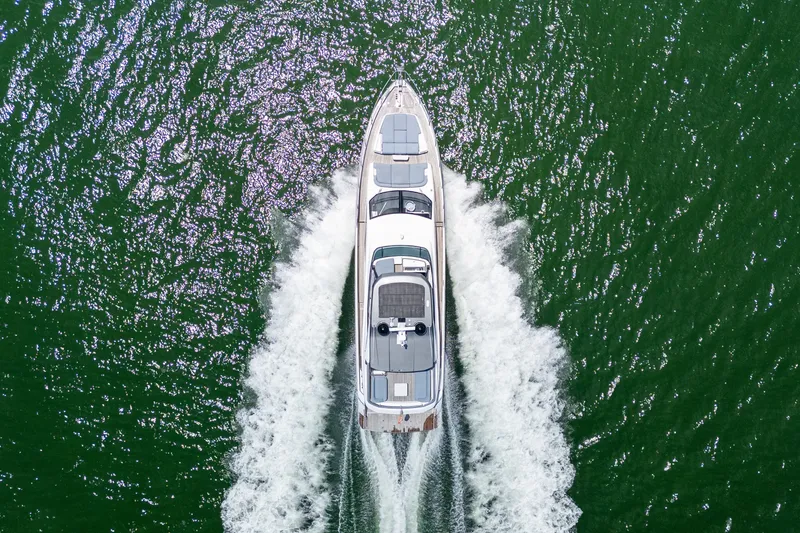 Slide: The Image of Aerial view of 2023 Azimut Fly 68 yacht cruising on green water. - 109