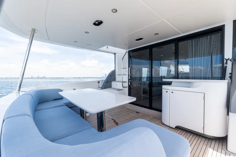 Slide: The Image of Luxurious 2023 Azimut Fly 68 yacht deck with seating and ocean view. - 14