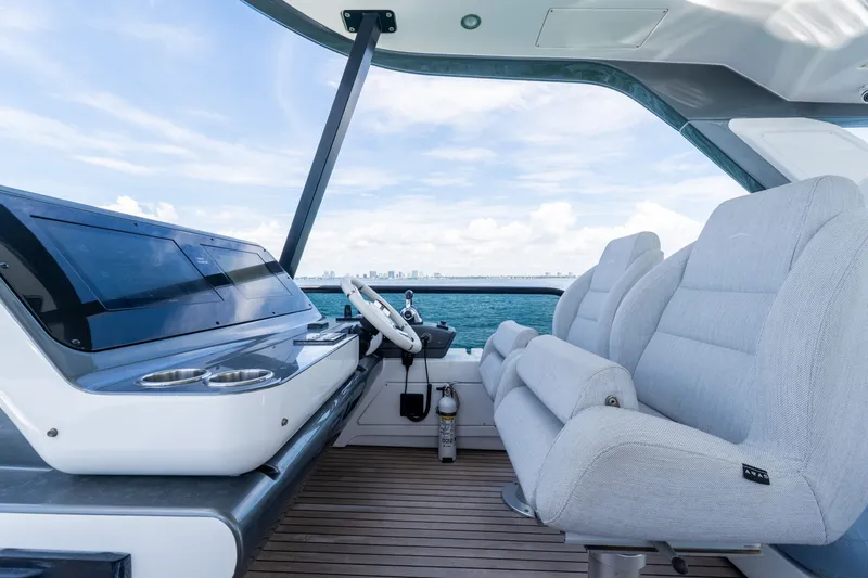 Slide: The Image of Luxurious helm of 2023 Azimut Fly 68 yacht with plush seating and ocean view. - 24