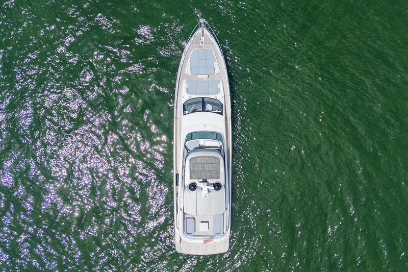 Slide: The Image of Aerial view of 2023 Azimut Fly 68 yacht on shimmering green water. - 99
