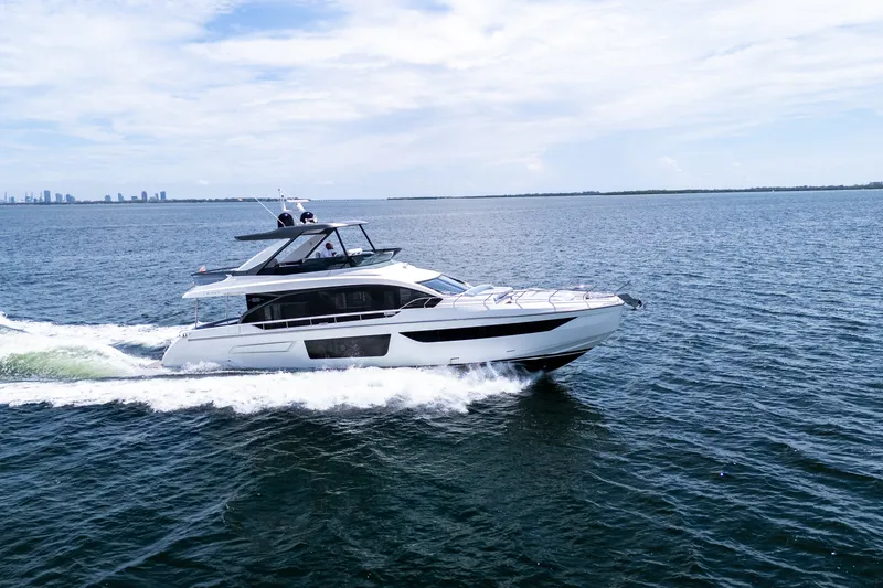 Slide: The Image of 2023 Azimut Fly 68 yacht cruising on open water under a clear sky. - 6