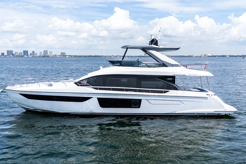 Slide: The Image of 2023 Azimut Fly 68 yacht cruising on open water under a clear sky. - 1