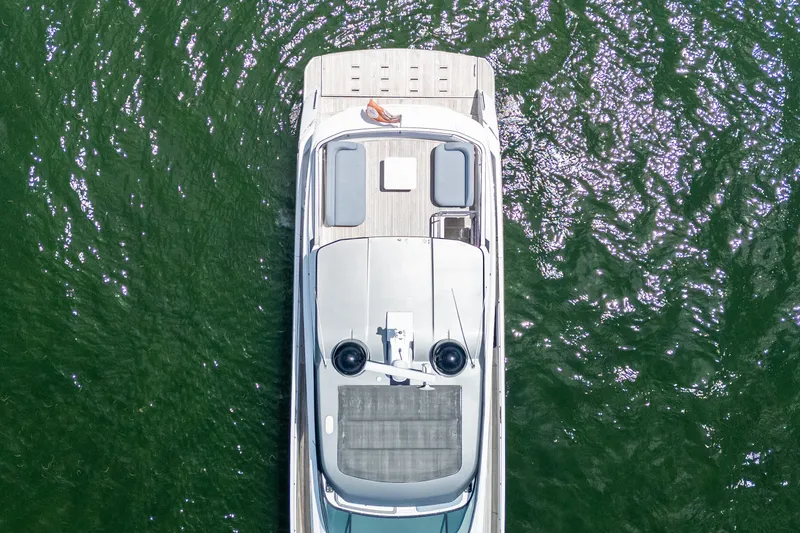 Slide: The Image of Aerial view of 2023 Azimut Fly 68 yacht on shimmering green water. - 101