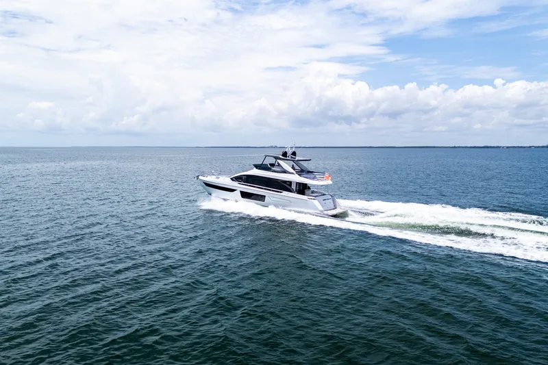 Slide: The Image of 2023 Azimut Fly 68 yacht cruising on open water under a partly cloudy sky. - 105