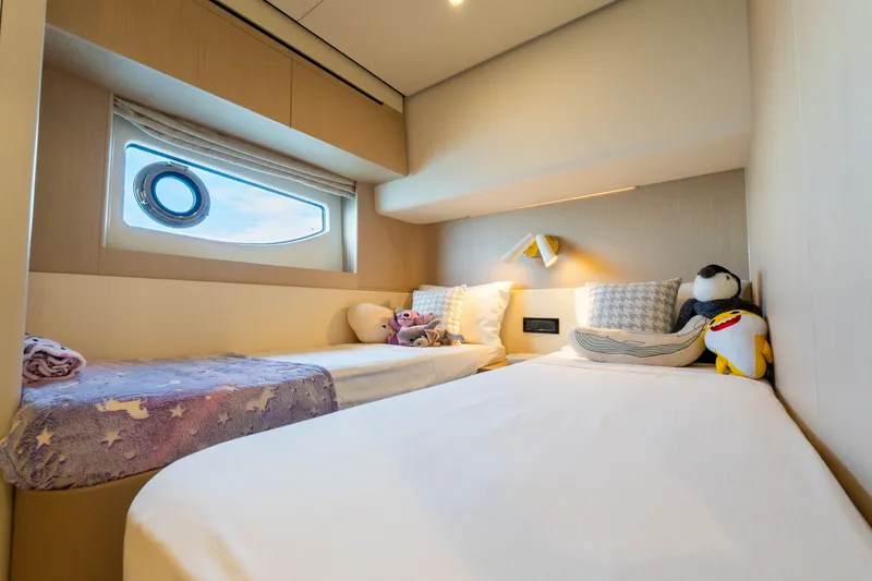 Slide: The Image of Luxurious 2023 Azimut Fly 68 yacht cabin with twin beds and plush toys. - 36