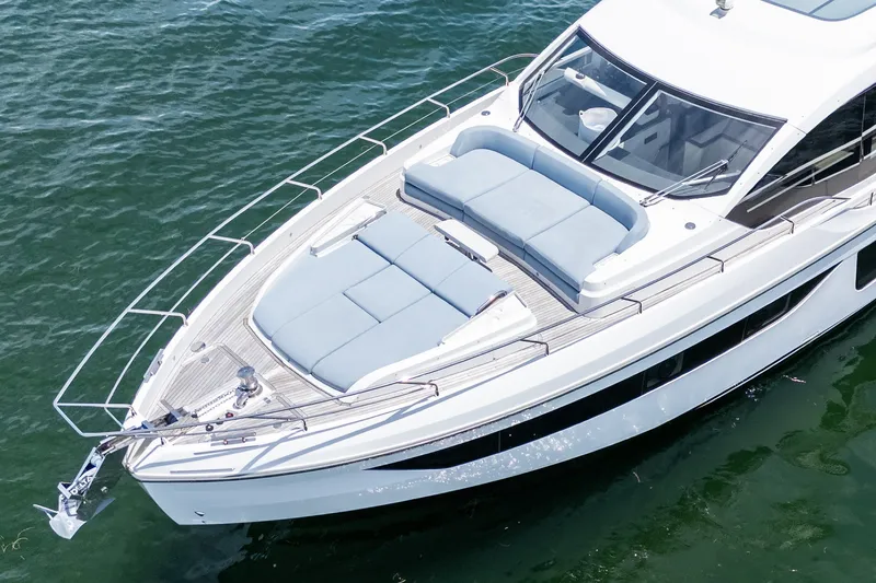 Slide: The Image of 2023 Azimut Fly 68 yacht on water, featuring sleek design and spacious deck. - 90
