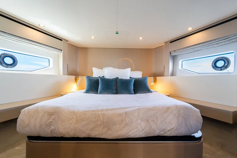 Slide: The Image of Luxurious bedroom interior of 2023 Azimut Fly 68 yacht with elegant bedding and porthole windows. - 42
