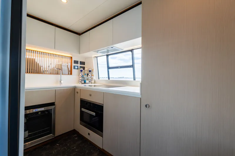 Slide: The Image of Modern kitchen interior on 2023 Azimut Fly 68 yacht, featuring sleek cabinetry and appliances. - 54