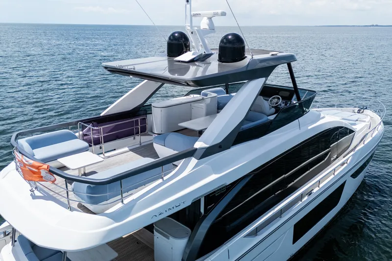 Slide: The Image of Luxurious 2023 Azimut Fly 68 yacht cruising on open water, featuring spacious deck and modern design. - 95