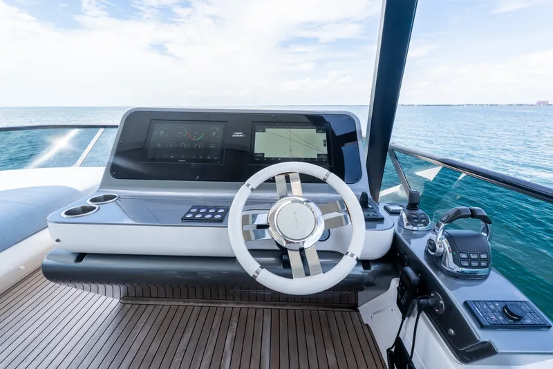 Slide: The Image of Modern helm of 2023 Azimut Fly 68 yacht with advanced navigation controls and ocean view. - 25