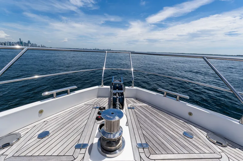 Slide: The Image of Bow view of 2023 Azimut Fly 68 yacht cruising on open water. - 74