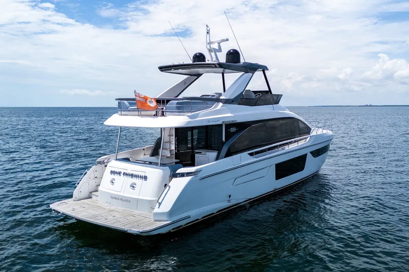 Slide: The Image of Luxury 2023 Azimut Fly 68 yacht cruising on open sea under clear skies. - 3