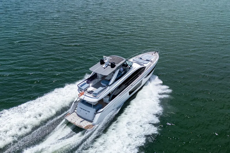 Slide: The Image of 2023 Azimut Fly 68 yacht cruising on open water, aerial view. - 104