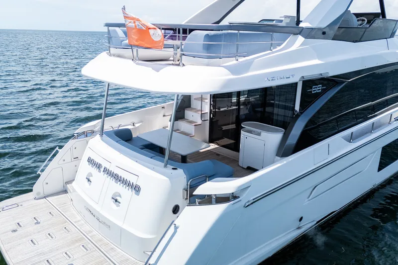 Slide: The Image of 2023 Azimut Fly 68 yacht on open water, featuring sleek design and spacious deck. - 96
