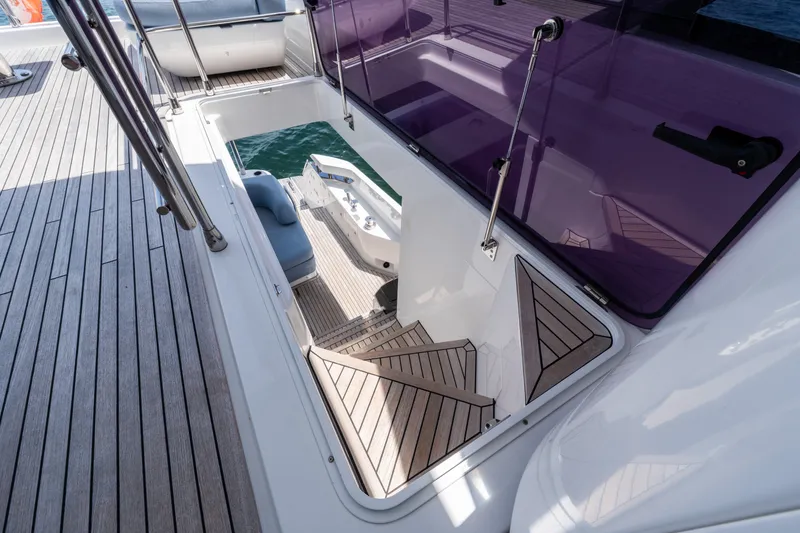 Slide: The Image of Staircase on 2023 Azimut Fly 68 yacht with wooden deck and glass railing. - 82