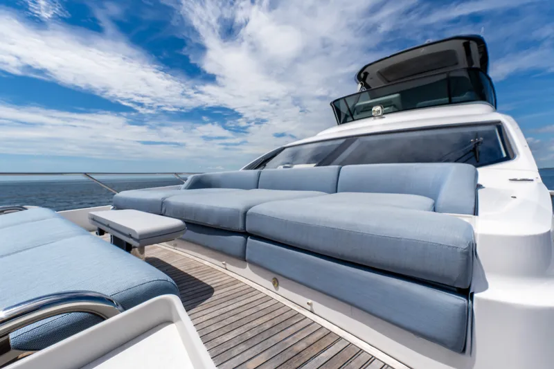 Slide: The Image of Luxurious 2023 Azimut Fly 68 yacht deck with plush seating under a vibrant sky. - 18