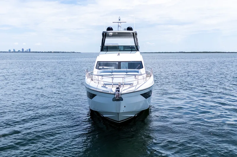 Slide: The Image of 2023 Azimut Fly 68 yacht on open water, city skyline in background. - 84