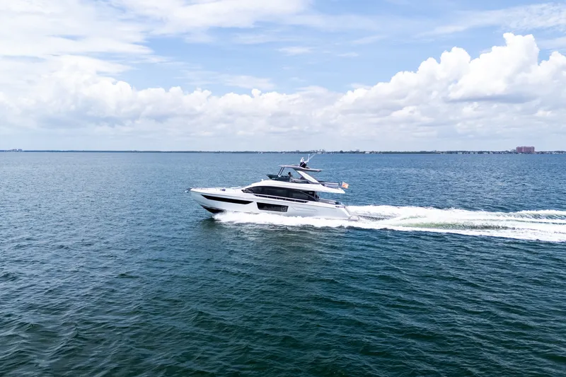 Slide: The Image of 2023 Azimut Fly 68 yacht cruising on open water under a partly cloudy sky. - 111