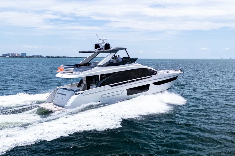 Slide: The Image of 2023 Azimut Fly 68 yacht cruising on open water under a clear sky. - 8