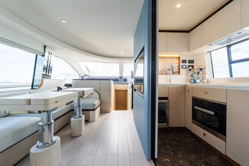 Slide: The Image of Luxurious interior of 2023 Azimut Fly 68 yacht, featuring modern kitchen and seating area. - 53