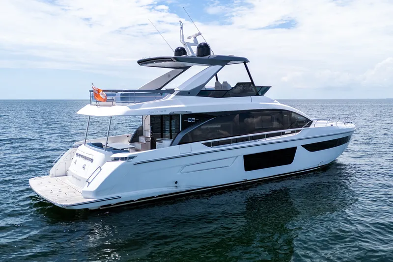 Slide: The Image of 2023 Azimut Fly 68 yacht cruising on open water under a clear sky. - 85