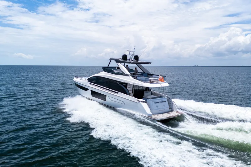 Slide: The Image of 2023 Azimut Fly 68 yacht cruising on open sea under a partly cloudy sky. - 7