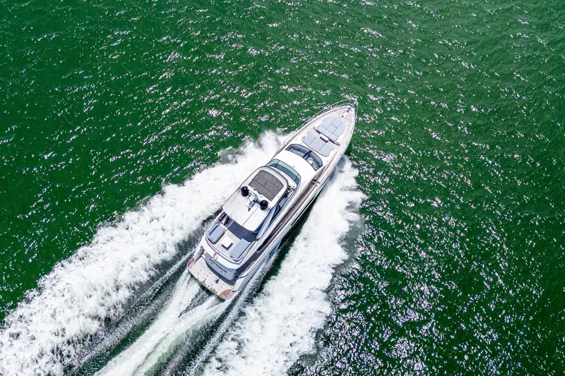 Slide: The Image of Aerial view of 2023 Azimut Fly 68 yacht cruising on green ocean waters. - 108