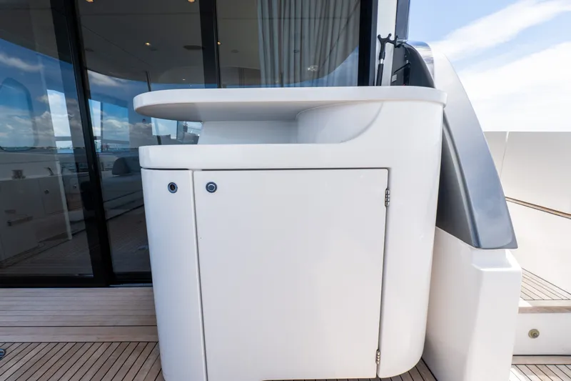 Slide: The Image of Luxury yacht Azimut Fly 68, 2023 model, featuring sleek outdoor cabinetry design. - 72