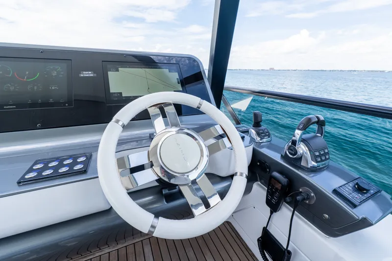Slide: The Image of Cockpit of 2023 Azimut Fly 68 yacht with modern steering and navigation controls. - 80