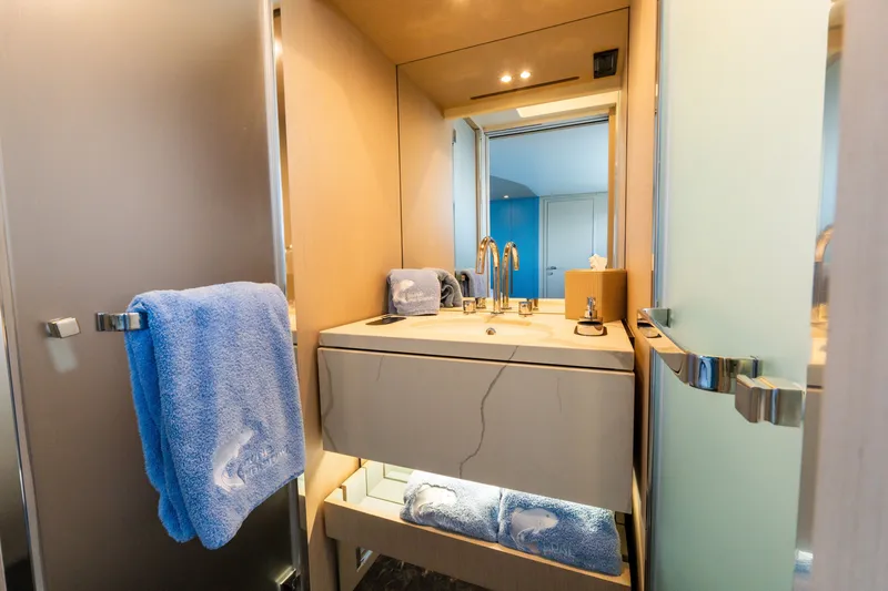 Slide: The Image of Luxurious bathroom interior of 2023 Azimut Fly 68 yacht with modern fixtures and blue towels. - 35