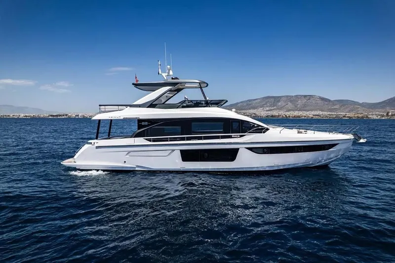 Slide: The Image of 2023 Azimut Fly 68 yacht cruising on open water with mountainous backdrop. - 3