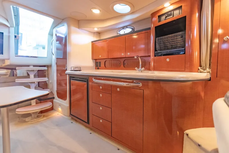 Slide: The Image of Interior of 2004 Sea Ray 340 Sundancer yacht with modern kitchen and seating area. - 37