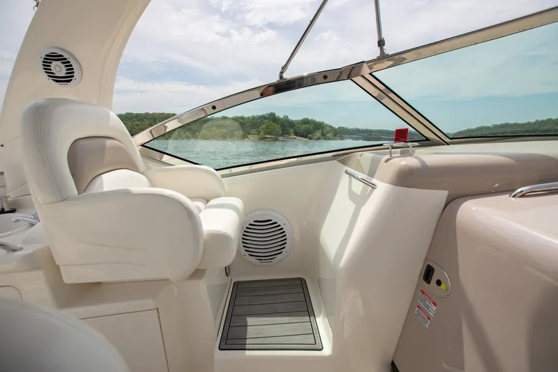 Slide: The Image of 2004 Sea Ray 340 Sundancer cockpit with white seating and scenic water view. - 19