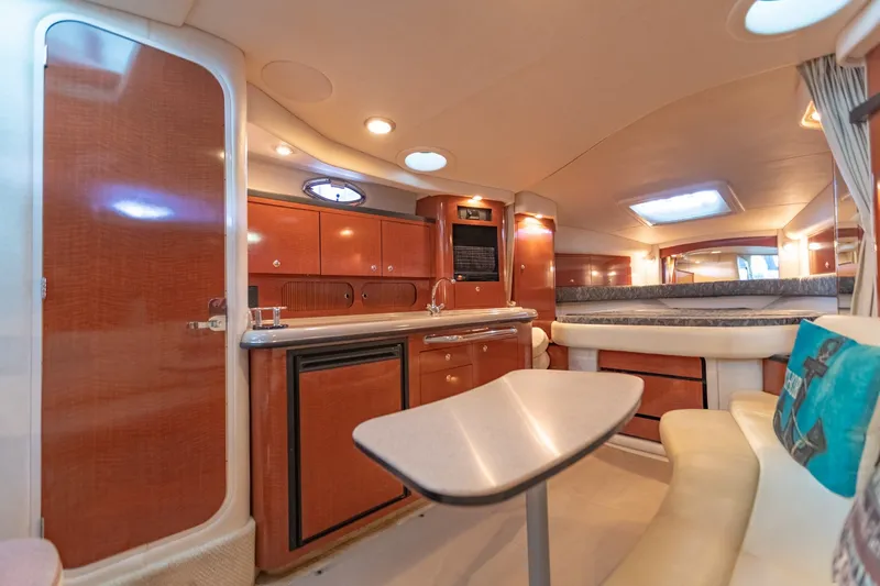 Slide: The Image of Interior of 2004 Sea Ray 340 Sundancer yacht with elegant wood cabinetry and cozy seating area. - 35