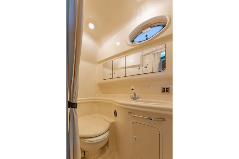 Slide: The Image of Bathroom interior of 2004 Sea Ray 340 Sundancer yacht, featuring sink and mirror. - 38
