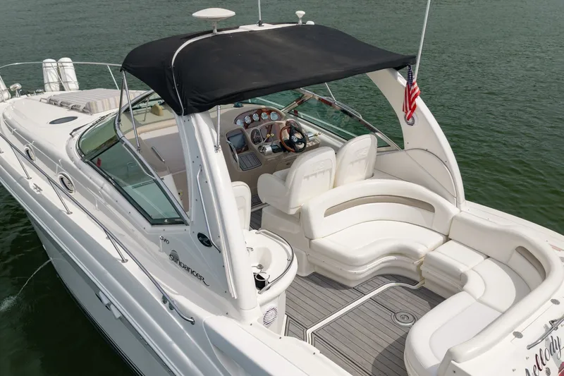 Slide: The Image of 2004 Sea Ray 340 Sundancer boat with spacious seating and sleek design on the water. - 7