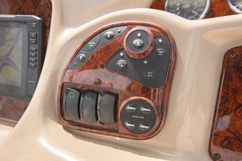 Slide: The Image of Control panel of a 2004 Sea Ray 340 Sundancer boat with woodgrain finish. - 28