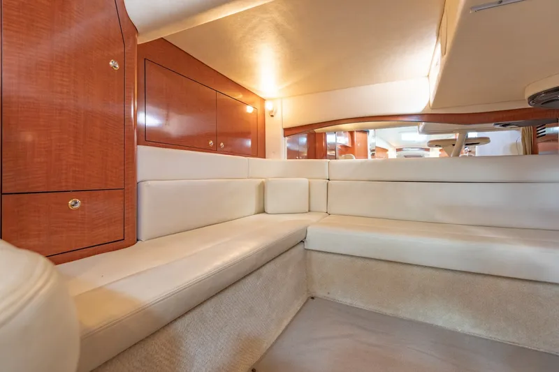Slide: The Image of Luxurious interior of 2004 Sea Ray 340 Sundancer yacht with plush seating and wooden cabinetry. - 31