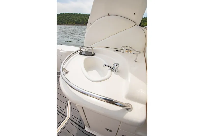 Slide: The Image of 2004 Sea Ray 340 Sundancer boat sink with chrome faucet and cup holders. - 22