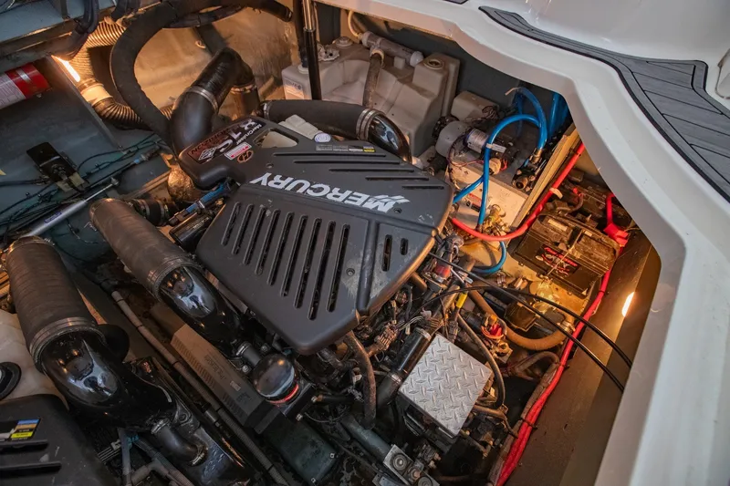 Slide: The Image of Engine compartment of a 2004 Sea Ray 340 Sundancer with Mercury components. - 43